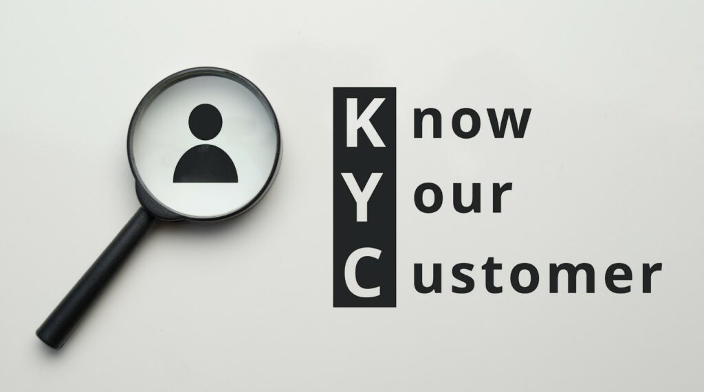 KYC black magnifying glass know your customer on gray white background