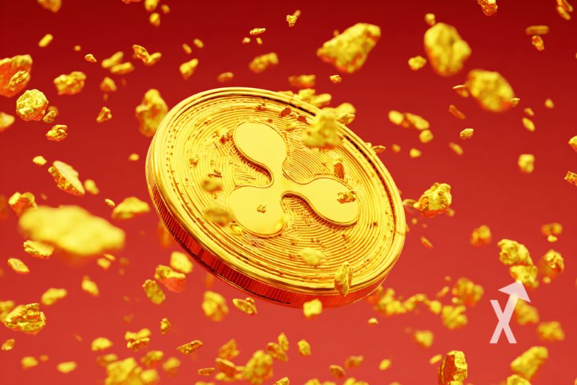 Yellow XRP coin on red background with gold particles flying.