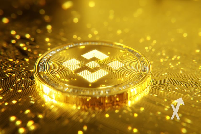 Gold BNB coin on shiny gold and yellow background.