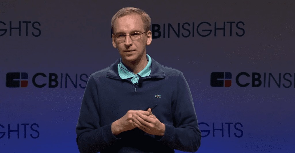 A real photograph of Michael Egorov at a conference