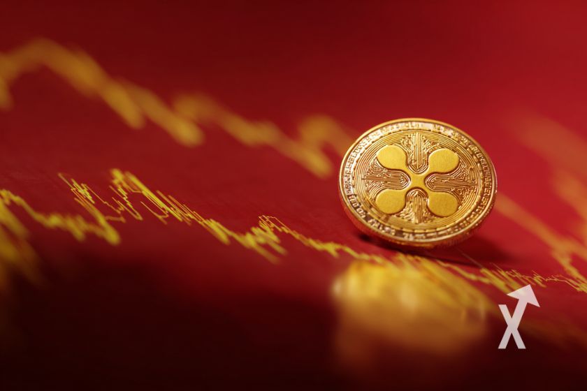 xrp coin en jaune sur un fond rouge avec trendline de prix jaune