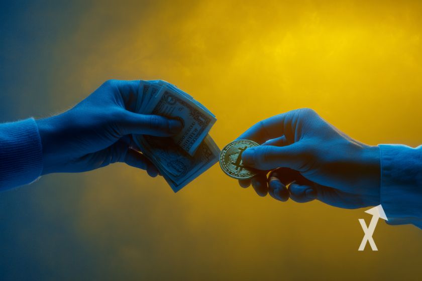 Dos manos intercambian dinero por Bitcoin.